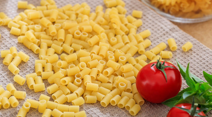 Raw macaroni pasta with tomatoes