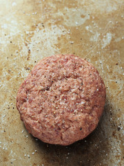 rustic uncooked seasoned hamburger patty