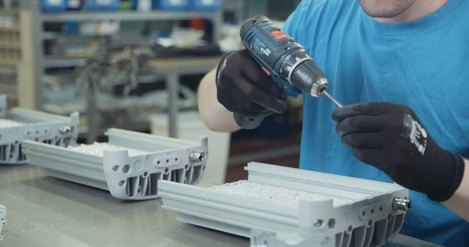 Worker in a LED lamps production line
