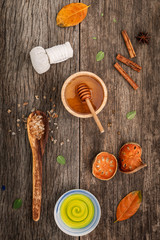 Composition of nature spa ingredients on the dark wooden table.