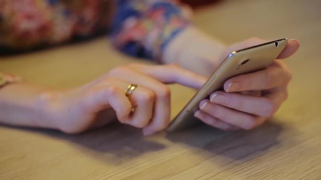 Woman using mobile phone in cafe