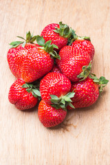 Red fresh strawberry fruits on wooden table.
