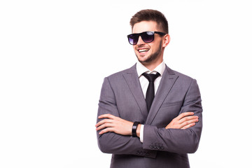 Portrait of a confident businessman with arms folded over white background