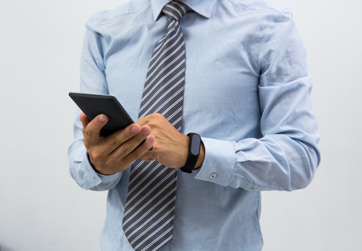 isolated business man with smart wristband and smartphone
