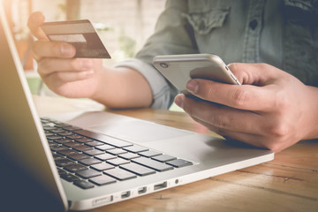 Online payment,Man's hands holding a credit card and using smart