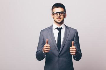 Businessman with okay gesture on white