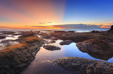 Beautiful vibrant seascape at sunset of Tanah Lot beach in bali, indonesia