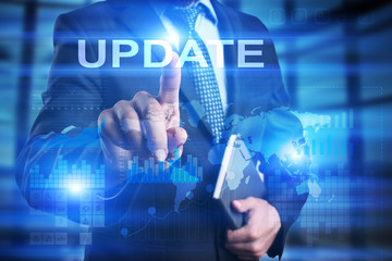 Obraz premium Businessman is pressing on the virtual screen and selecting Update.