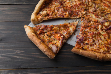 slice of pizza on a wooden background