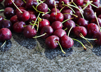 Sweet cherries on dark granite background