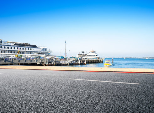empty road near dock in san francisco in blue sky - Powered by Adobe