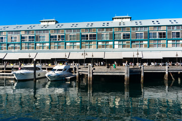 Finger wharf restaurants and hotel in Woolloomooloo bay with unrecognisable people in the distance....