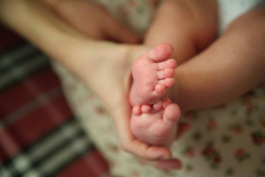 Baby feet in mommy's hands