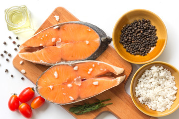 fresh fish salmon raw salmon steak with sea salt pepper and Dill Weed isolated on a white background
