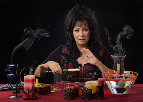 Fortuneteller drips candle wax into water