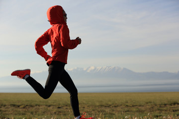 young fitness woman runner running on road