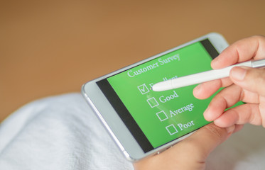 customer survey checking in online survey on smart phone with mu