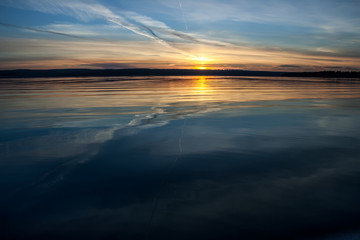 sunset over blue water
