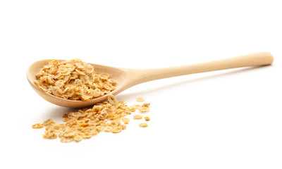 Heap of oat flakes with wooden spoon