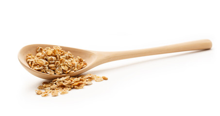Heap of oat flakes with wooden spoon