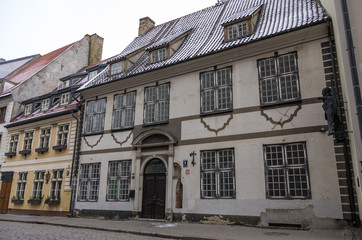 Obraz premium Riga, Latvia. Traditional medieval houses in street of Riga old town. Winter and snow.