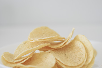 snack food of potato chips crispy  in white ceramic bowl  on white background