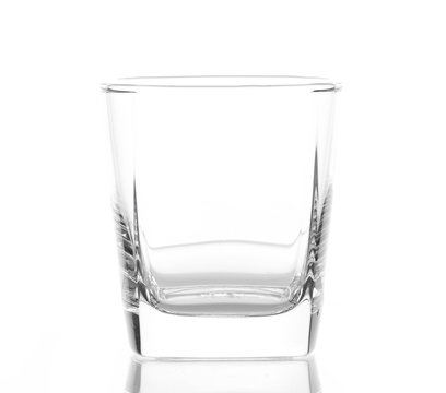 Empty glass for whiskey on white background