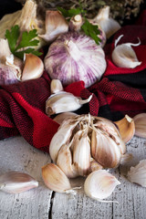 Purple garlics on a napkin on a wooden rustic table