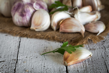 Purple garlics on a napkin on a wooden rustic table