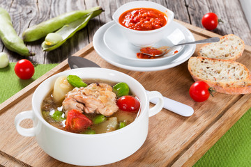 Braised chicken things with new potatoes and tomatoes