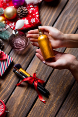 female hands holding perfume