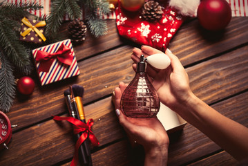 female hands wrapping perfume