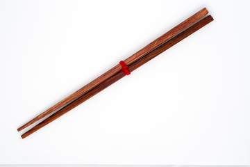 Wooden chopsticks on white background.