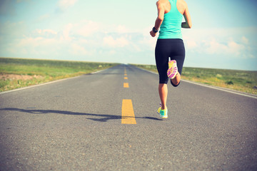 young fitness woman runner running on road