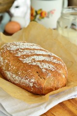 Homemade bread, milk, cream on a wooden background