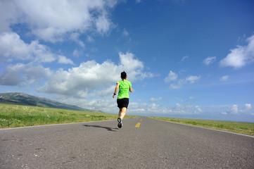 Obraz premium healthy lifestyle young woman runner running on beautiful road
