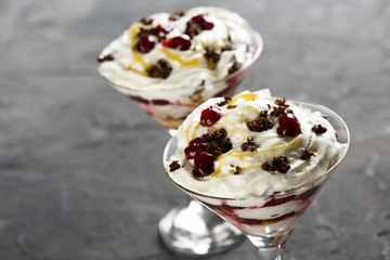 Layered dessert with whipped cream and cherry