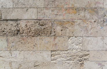 gray wall of sandstone blocks of rectangular shape with smooth edges