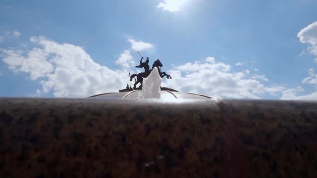 Fountain "World Clock" in Moscow near the Kremlin in background of a sun. S-log - High Dynamic Range. Slow motion, high speed camera, 250fps