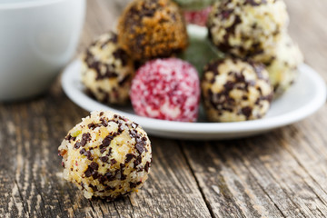 Delicious vegetarian truffle candies on wodden table.