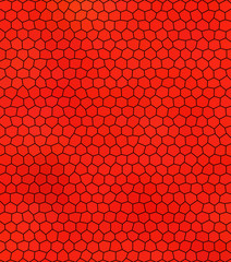 Abstract red hexagonal background with many small hexagons and black joints.