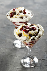 Layered dessert with whipped cream and cherry