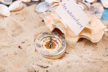 Fototapeta na wymiar Compass in the sand with Message - Sea adventure
