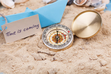 Fototapeta na wymiar Compass in the sand with Message - Time is coming