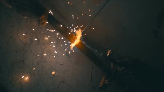 Welding works on a black background and a lot of sparks. Slow motion, high speed camera, 250fps