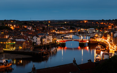 WHITBY, ENGLAND - JULY 16: The swing bridge within Whitby harbour, at night. In Whitby, North Yorkshire, England. On 16th July 2016.