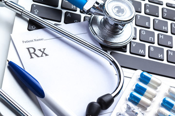 Medical stethoscope on computer keyboard