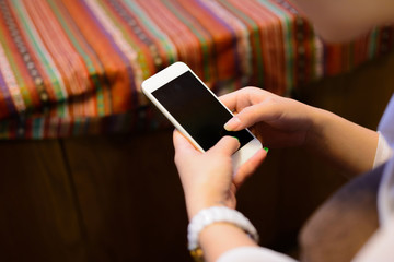 The hands holding a digital tablet.