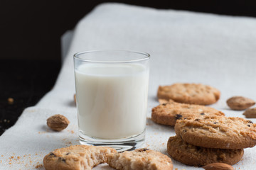 Cookies pile with chocolate chip and almond on light textile background. Delicious morning snacks for breakfast, brunch and lunch. Appetizing, healthy and fast food