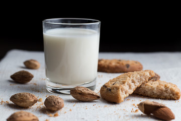 Cookies pile with chocolate chip and almond on light textile background. Delicious morning snacks for breakfast, brunch and lunch. Appetizing, healthy and fast food